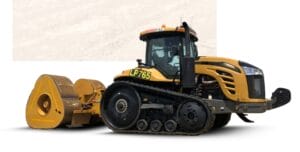A yellow heavy-duty tractor with a black cab and large tracks is equipped with a yellow towing attachment at the back. The vehicle is set against a plain, light background.