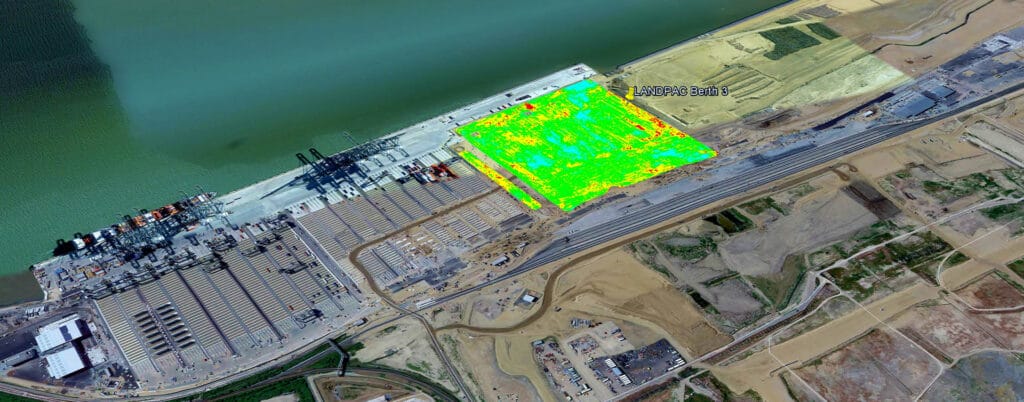 Aerial view of a port area featuring docks with cargo containers and cranes. A highlighted green thermal image, labeled "LANDPA Batch 2," overlays part of the land, showcasing Project Design Services' influence. Adjacent are roads and undeveloped land.