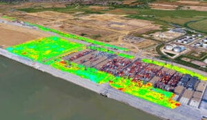 Aerial view of London Gateway, a sprawling port facility teeming with shipping containers and cranes. Colored overlays highlight vegetation coverage amidst the logistics hub, where industrial buildings and fields form the surrounding landscape.