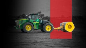 A green and yellow tractor with large tires pulls a yellow road roller over dirt. The background is mostly black and white, with a bold red vertical rectangle highlighting the roller.