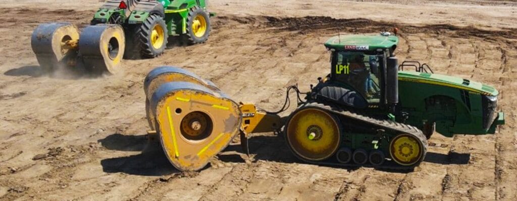 Two green tractors with yellow rollers work, showcasing Modulus vs Density in ground improvement.